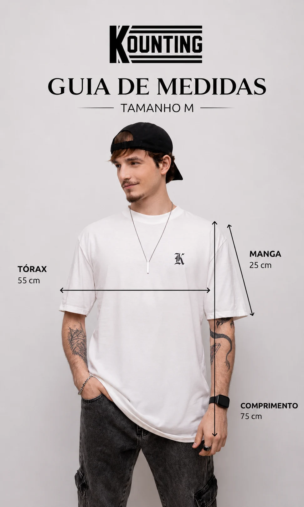 Guia de medidas oficial da linha Oversized Essential no tamanho M, com medidas de tórax, comprimento e manga